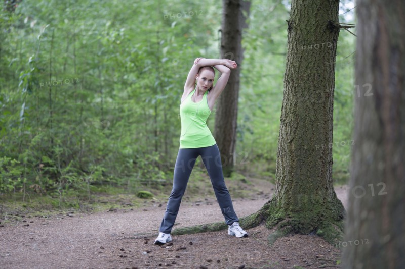 Woman stretching in forest. The Netherlands, Erp.
Photo : Mark de Leeuw