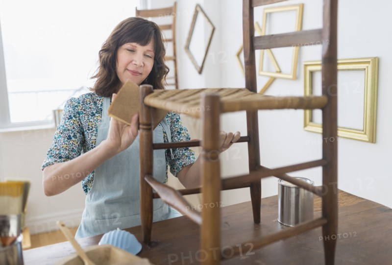 Woman restoring antique furniture.