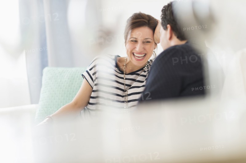 Couple sitting on sofa.