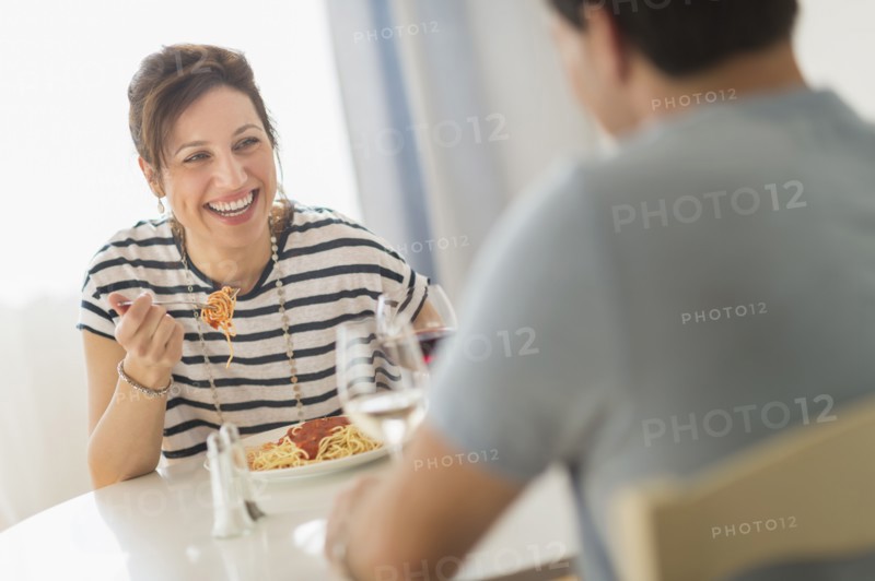 Couple eating spaghetti.