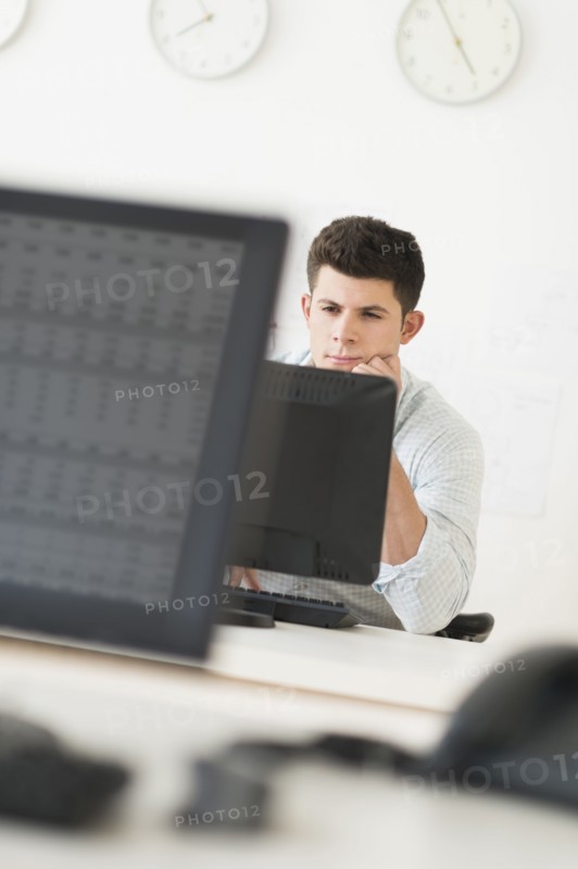 Young man sitting in front of desk and working.