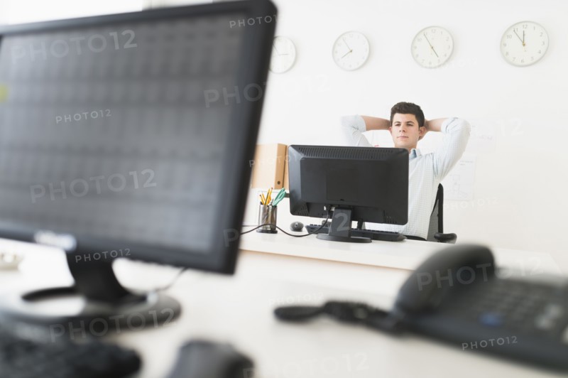Young man sitting in front of desk and working.
