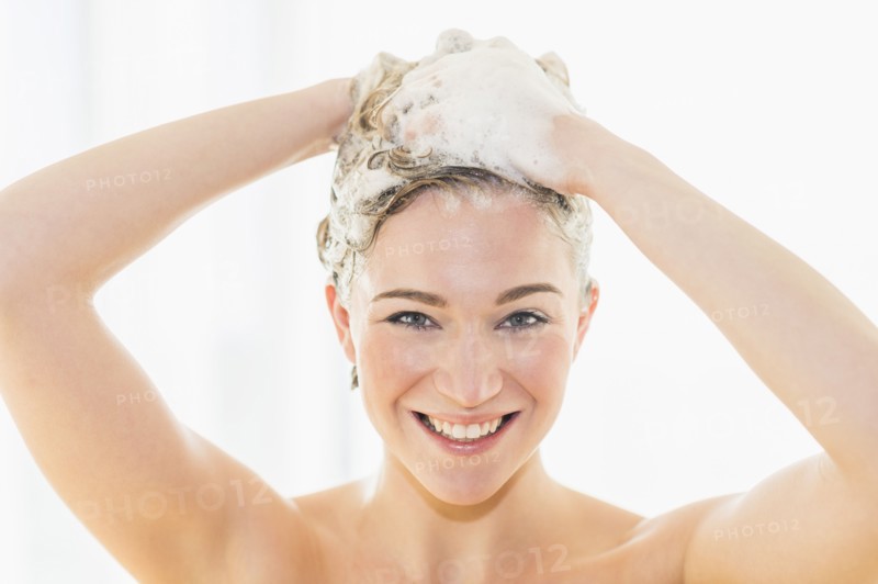 Beautiful woman washing hair.