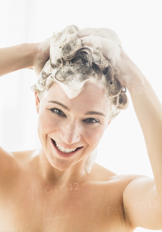 Beautiful woman washing hair.