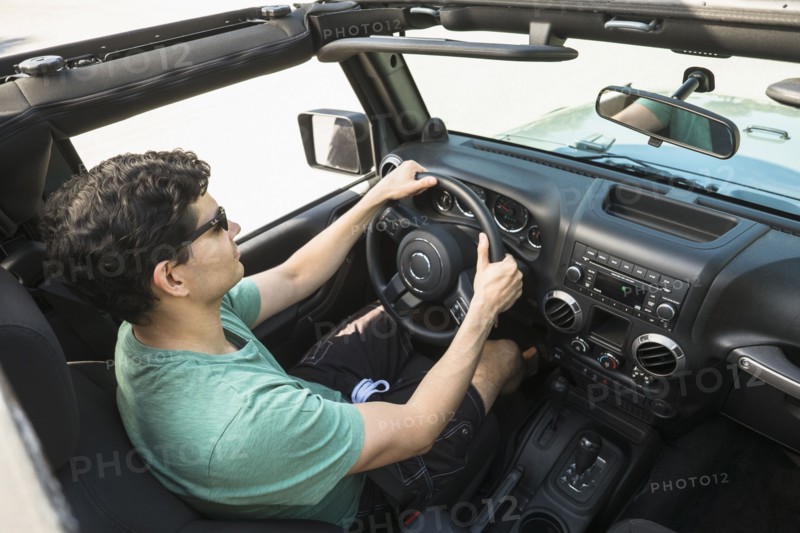 Elevated view of man driving car.