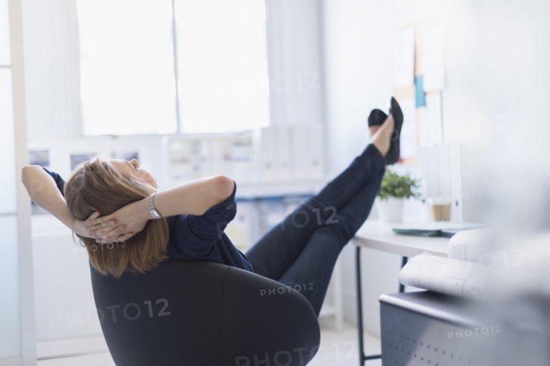 Business woman relaxing in office.