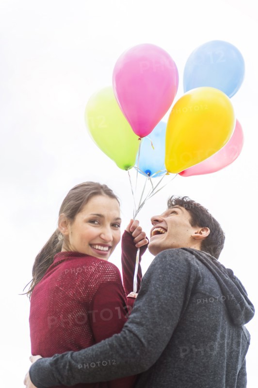 Young couple with balloons.