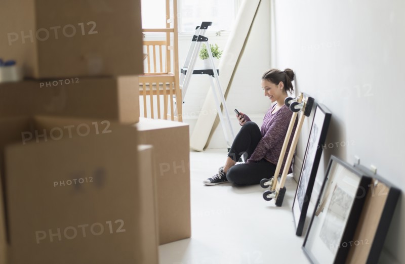 Young woman moving into new flat.