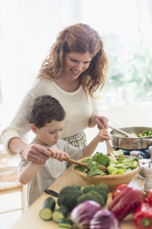 Mother and son (6-7) cooking together.