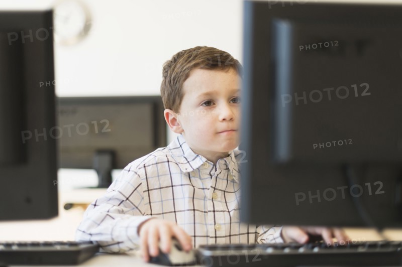 boy (6-7) using computer.