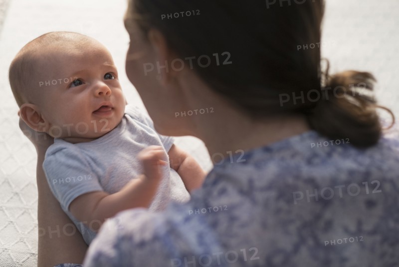 Mother holding baby boy (2-5 months).
