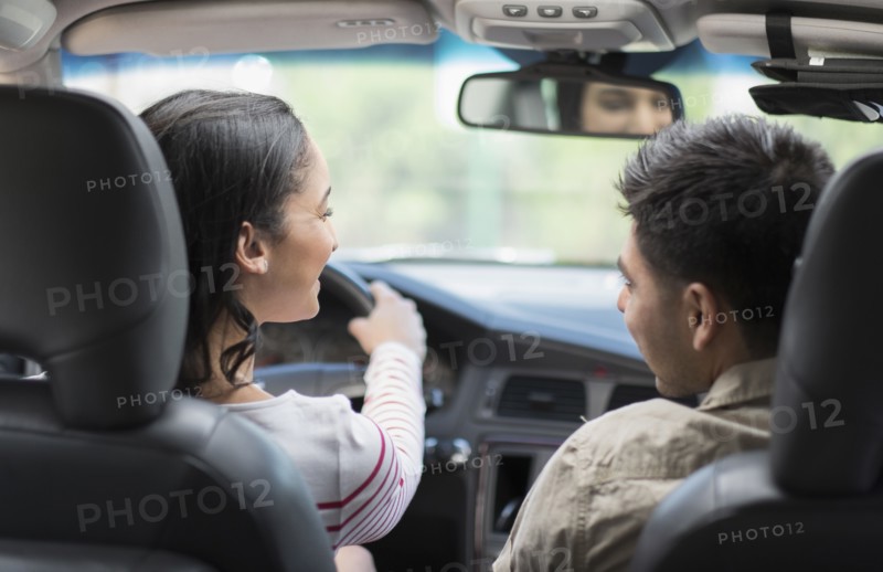 Young couple traveling in car.