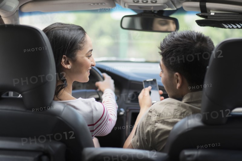 Young couple traveling in car.
