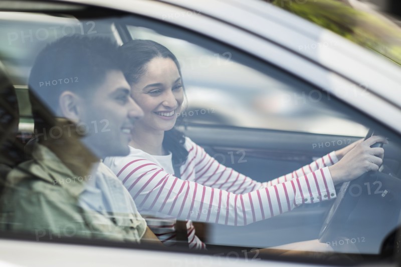 Young couple traveling in car.