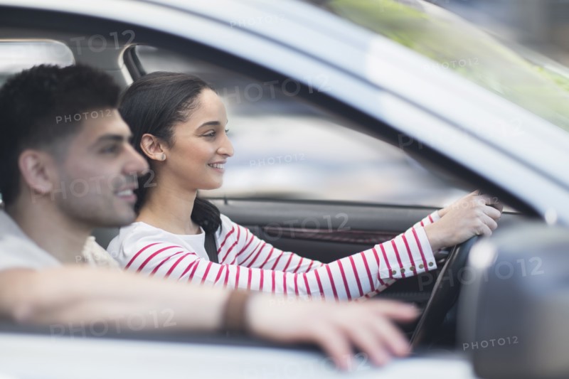 Young couple traveling in car.