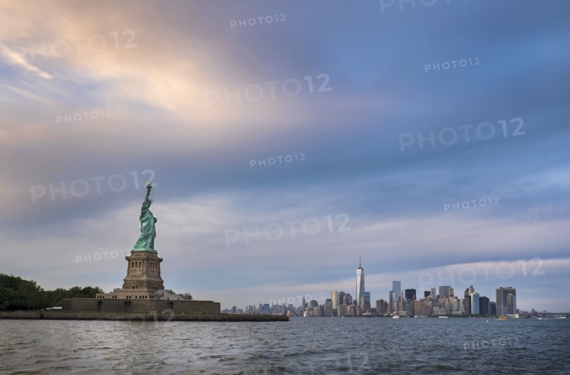Statue of Liberty with city skyline in background.