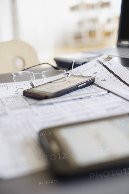 Close up of glasses on paperwork.