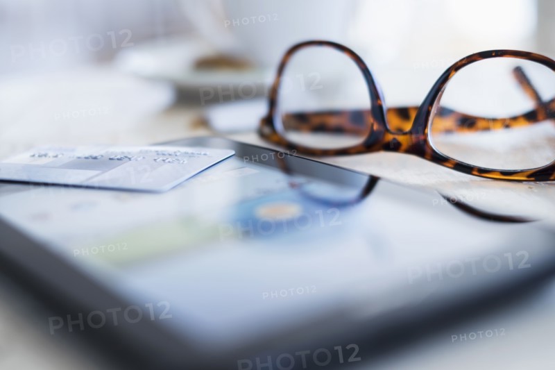 Close up of glasses and smartphone on table.