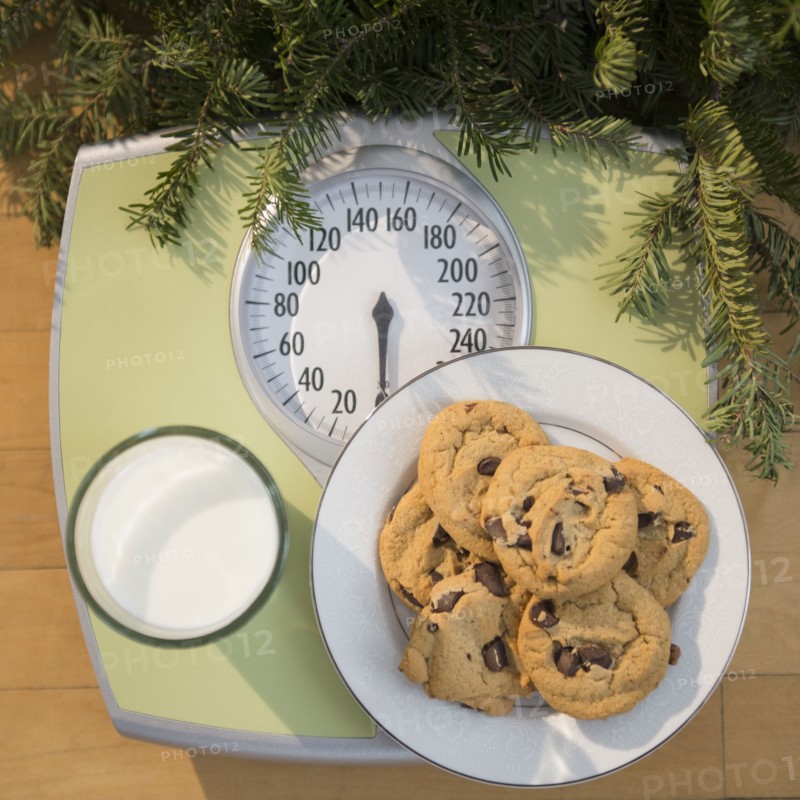 Studio Shot of cookies and milk on bathroom scale.
Photo : Jamie Grill