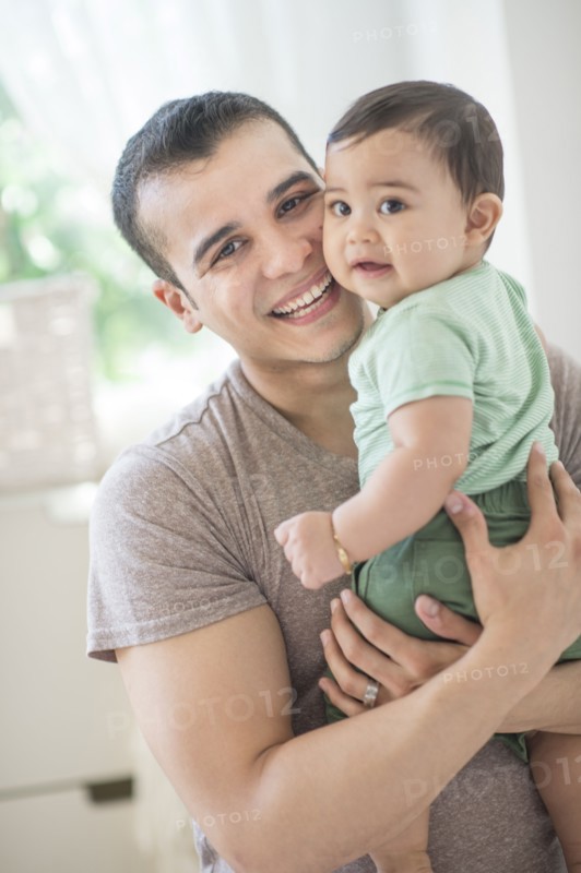 Father holding his son (6-11 months).