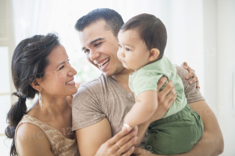 Family with baby son (6-11 months) in bedroom.