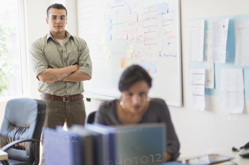 Two people working in office.