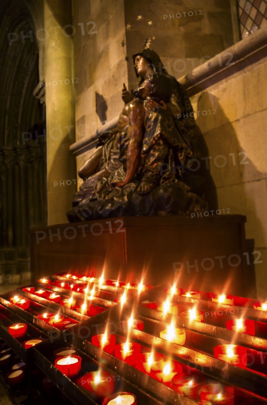 Candles in front of Virgin Mary statue in Monastery of Jeronimos. Lisbon, Portugal.