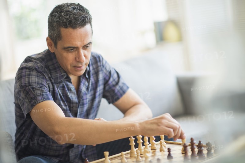 Mature man playing chess.