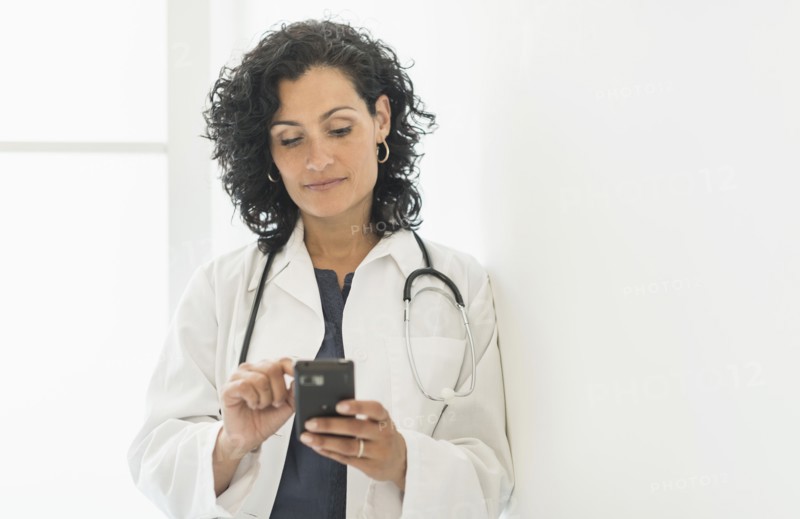 Female doctor using cell phone.