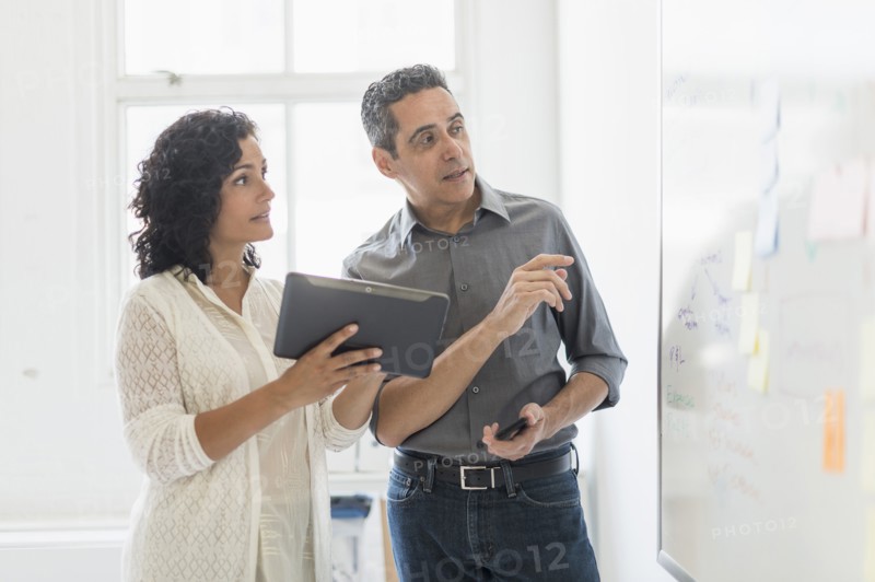 Man and woman working together in office.