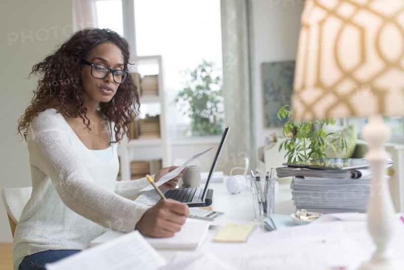 Woman using laptop at home.