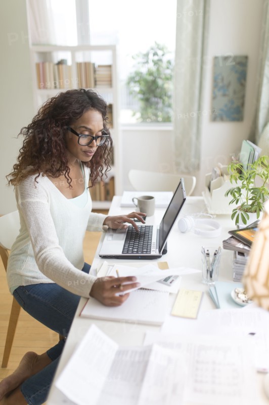 Woman paying bills via internet.