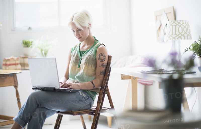 Woman using laptop at home.