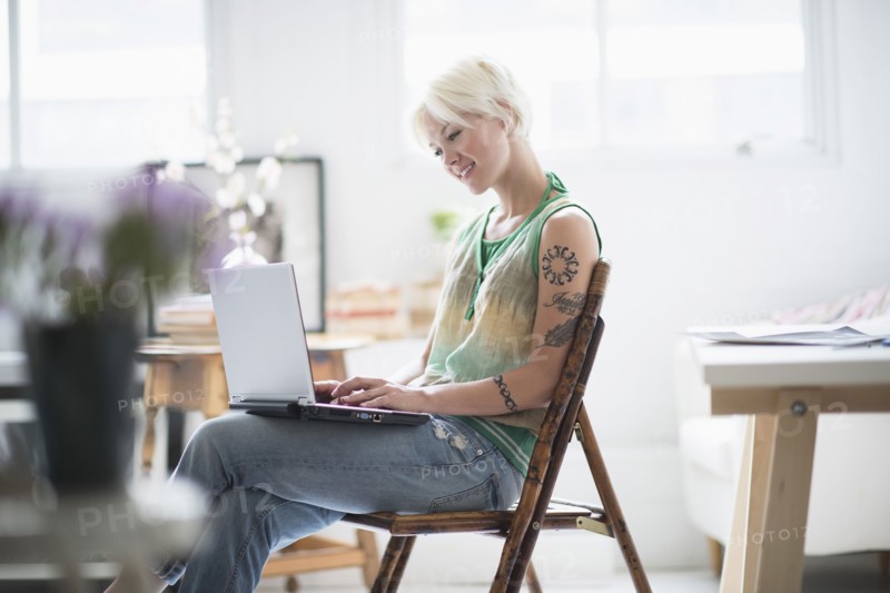 Woman using laptop at home.