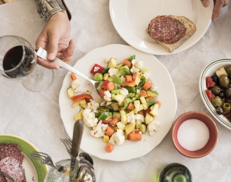 Hand serving salad.