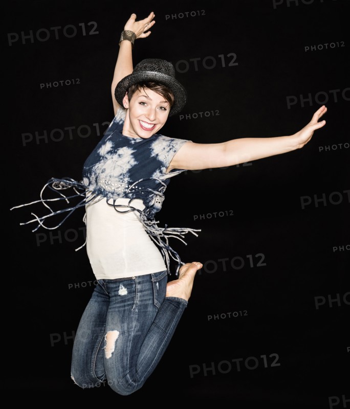 Portrait of young woman jumping.