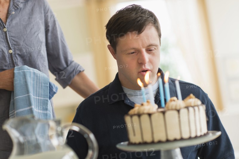 Man with down syndrome celebrating birthday.