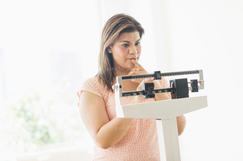 Woman standing on scale.