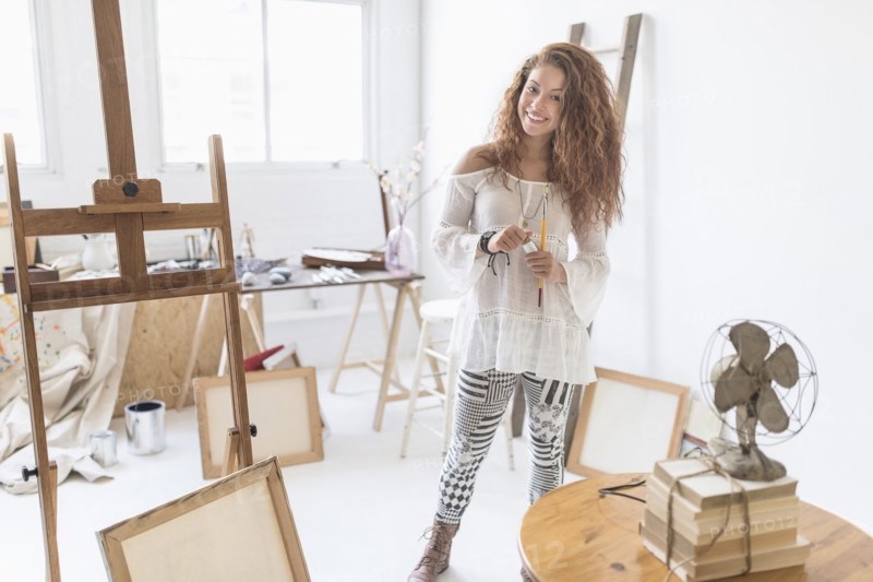 Young female artist in studio.