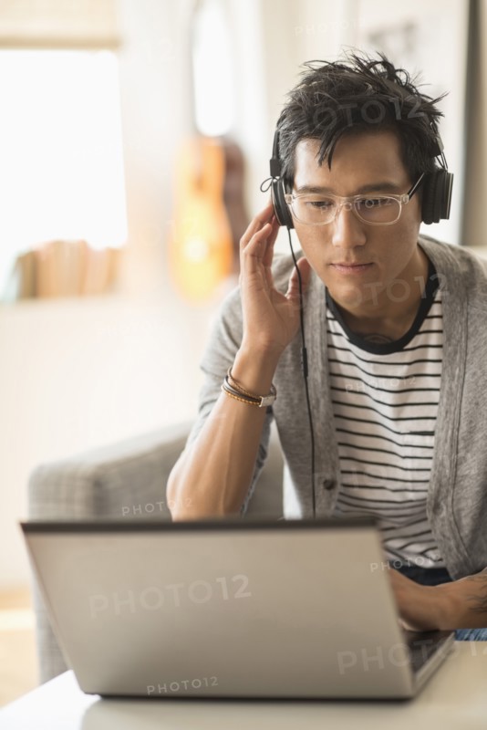 Man mixing music on laptop.