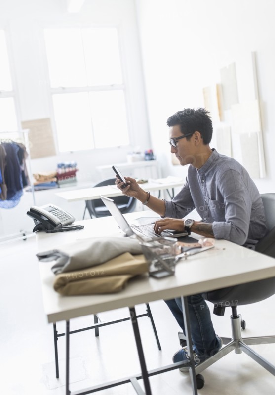 Side view of man working in studio.