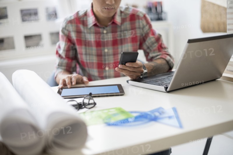 Man text messaging in office.