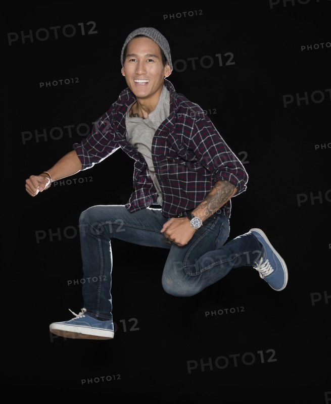 Studio shot of man jumping.