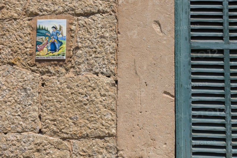Close up of tile with angels on wall. Valldemossa, Mallorca, Spain.