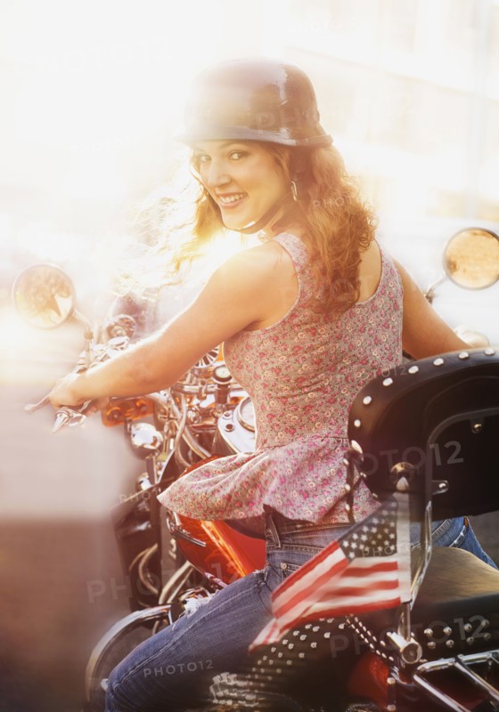 Young woman riding motorcycle.