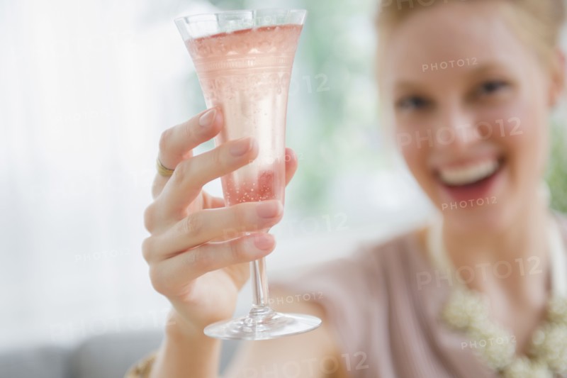 Young woman toasting with champagne
