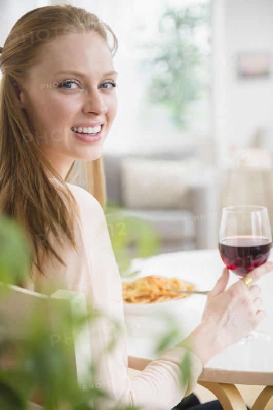 Woman having meal with red wine