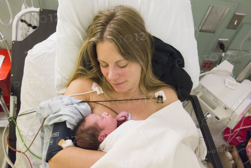 Mother holding newborn daughter