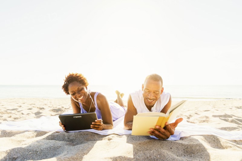 Man and woman reading on beach