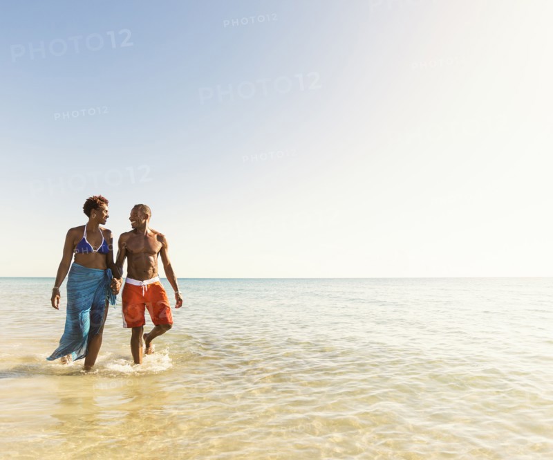 Mature couple walking in sea